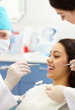 dentist-examining-patient-s-teeth